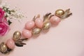 Pink and Gold Easter Eggs. Pastel Easter Concept with Eggs, Flowers and Feathers. Punchy Pastels