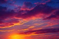 Pink and gold fluffy clouds in dramatic sunset sky.