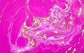 Pink, gold and green mixed inks spilled on white paper background. Golden glitter texture. Royalty Free Stock Photo