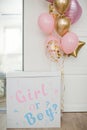 Pink and golden balloons with text `it`s a girl` gender reveal party.