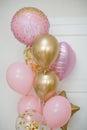 Pink and golden balloons with text `it`s a girl` gender reveal party.