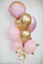 Pink and golden balloons with text `it`s a girl` gender reveal party.