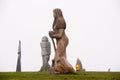 Pink granit statue of woman surrounded by geese