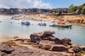 Pink Granite Coast, yachts and boats in harbor, textured unique pink granite boulders. Ploumanach, Perros-Guirec, Brittany France. Royalty Free Stock Photo