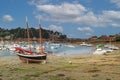 Pink Granite Coast, yachts and boats in the harbor parking at low tide. Ploumanach, Perros-Guirec, Brittany, France. Royalty Free Stock Photo