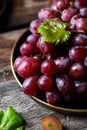 Pink grape on wooden table on wooden background. Vine grape. Still life of food. Royalty Free Stock Photo