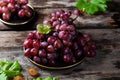 Pink grape on wooden table on wooden background. Vine grape. Still life of food. Royalty Free Stock Photo