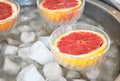 Pink grapefruit halves in glass bowls on ice Royalty Free Stock Photo