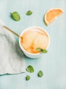 Pink grapefruit sorbet with fresh mint leaves in white bowl Royalty Free Stock Photo