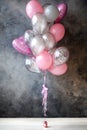 Pink, gray balloons on a gray background. Birthday, Valentine`s Day