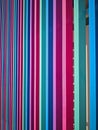 Pink, green, blue and magenta wooden decorative elements on the building`s facade Royalty Free Stock Photo