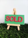 Pink and green sold sign on a wood easel on green grass Royalty Free Stock Photo