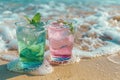 pink and green summer drinks with drops on the ocean beach