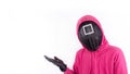 Pink Guard from Squid Game of new Netflix show. Squid Game red guard holds hand up for text on white background. Space for text. Royalty Free Stock Photo