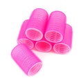 Pink hair curlers on white