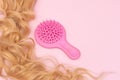 Pink hairbrush and long natural blonde hair Royalty Free Stock Photo