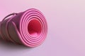 Pink half rolled yoga mat on magenta background. Fitness and health. Exercise equipment. Yoga and pilates Royalty Free Stock Photo