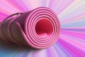 Pink half rolled yoga mat on magenta background. Yoga and pilates. Fitness and health. Exercise equipment Royalty Free Stock Photo