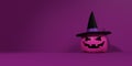 Pink Halloween pumpkin lantern with witch\'s hat - purple background Royalty Free Stock Photo
