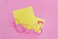 Pink headphones for concept design. Mock up of a blank yellow sheet on a pink background. Flat lay, copy space. Modern style Royalty Free Stock Photo