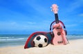 Pink headphones ukulele and handcraft hat football on blue sky.