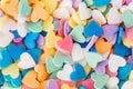 Pink heart in heap of colorful hearts candies. Valentine day holiday.