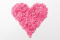 Pink heart made of many smaller hearts on a white background