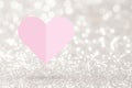 Pink heart paper fold on silver glitter background