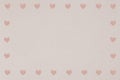 Pink heart patterned frame on a light brown background