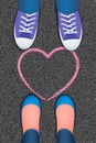 Pink heart pictured on the asphalt