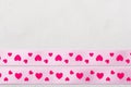 Pink heart ribbon on cloth background