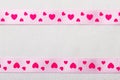 Pink heart ribbon on cloth background