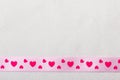 Pink heart ribbon on cloth background