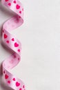 Pink heart ribbon on cloth background