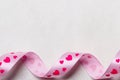 Pink heart ribbon on cloth background