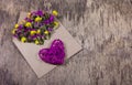 Pink heart and romantic letter. Flowers in the envelope.