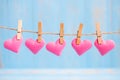 Pink heart shape decoration hanging on line with copy space for text on blue wooden background. Love, Wedding, Romantic and Happy Royalty Free Stock Photo