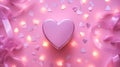 Pink heart shape gift box on silk fabric with yellow light garland glow as flat lay Royalty Free Stock Photo