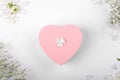 Pink heart shape gift box on a white backround with small withe flowers Royalty Free Stock Photo