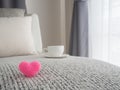 Pink heart shape sign on modern vintage sofa and white coffee cu Royalty Free Stock Photo