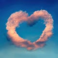 Pink heart-shaped cloud over blue sky Royalty Free Stock Photo