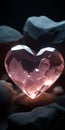 A pink heart-shaped crystal on black stones. Wallpaper for your phone. Royalty Free Stock Photo