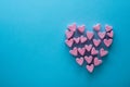 Pink heart-shaped marshmallows stacked on a blue background with space for copy. Marshmallow heart.Valentine`s day concept theme Royalty Free Stock Photo