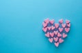 Pink heart-shaped marshmallows stacked on a blue background with space for copy. Marshmallow heart.Valentine`s day concept theme Royalty Free Stock Photo