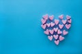 Pink heart-shaped marshmallows stacked on a blue background with space for copy. Marshmallow heart.Valentine`s day concept theme Royalty Free Stock Photo