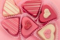 Pink heart shaped petit fours cakes seen from above decorated around pink letters stating Love Royalty Free Stock Photo