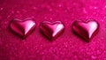 pink heart on a sparkly pink background red hearts on a pink glitter background. The hearts are bright and have some reflections