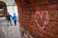 Pink heart symbol painted as scrawl on wall