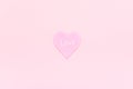 Pink heart with text LOVE on pink background, central composition, minimal style. Concept declaration of love, love confession. Royalty Free Stock Photo