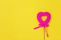 Pink heart on a yellow background. Bow.Love